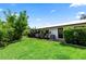 Landscaped backyard with healthy green grass, mature trees, and a well-maintained lawn at 225 Temple Cir, Eustis, FL 32726