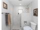 Bright bathroom featuring a modern shower with niche, toilet, and towel rack at 225 Temple Cir, Eustis, FL 32726