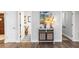 Bright entryway featuring decorative cabinet with eye-catching artwork and stylish tile flooring detail at 225 Temple Cir, Eustis, FL 32726