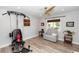 Exercise room featuring a Bowflex machine, a comfortable chair, and natural lighting at 225 Temple Cir, Eustis, FL 32726