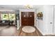 Grand foyer featuring a custom double door entry, hardwood floors, and contemporary light fixtures at 225 Temple Cir, Eustis, FL 32726