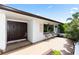 Welcoming front entrance features a double door and seating area, complemented by lush landscaping at 225 Temple Cir, Eustis, FL 32726