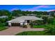 Stunning single-story home boasting a well-manicured lawn and a modern metal roof for lasting curb appeal at 225 Temple Cir, Eustis, FL 32726