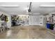 Bright garage with pegboard walls for tool storage, workbench, and white service door at 225 Temple Cir, Eustis, FL 32726