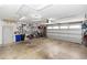 Spacious garage with work area, tool storage, bicycles, and an automatic garage door at 225 Temple Cir, Eustis, FL 32726