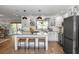 Bright, updated kitchen featuring white cabinetry, a marble island, and stainless steel appliances at 225 Temple Cir, Eustis, FL 32726