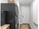 Laundry room features stacked washer and dryer, light paint, and turtle-themed rug at 225 Temple Cir, Eustis, FL 32726