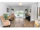Living area featuring wood floors, sliding glass doors to pool, piano and workspace at 225 Temple Cir, Eustis, FL 32726