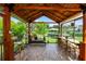 Elegant covered outdoor bar area with scenic views and ample seating, perfect for enjoying the beautiful surroundings and outdoor dining at 225 Temple Cir, Eustis, FL 32726