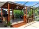 Charming covered outdoor bar area complete with bar seating, and a lounge space for relaxed outdoor entertaining at 225 Temple Cir, Eustis, FL 32726