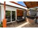 Cozy covered outdoor bar with a modern grill, comfortable seating, and stylish accents, perfect for outdoor living and gatherings at 225 Temple Cir, Eustis, FL 32726