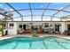 Beautiful pool and lanai showcasing multiple seating areas, and outdoor entertaining space, all designed for outdoor living at 225 Temple Cir, Eustis, FL 32726