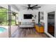 Inviting sunroom featuring a comfortable sofa, mounted TV, and access to a screened-in pool area, ideal for relaxation at 225 Temple Cir, Eustis, FL 32726