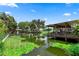 Scenic waterfront view with docks and serene water reflections under a blue sky at 225 Temple Cir, Eustis, FL 32726