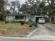 Charming single-story home featuring a well-kept lawn and a covered parking area at 2429 S Laurel Ave, Sanford, FL 32771