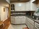 Corner kitchen with white cabinetry, neutral countertops, and stainless steel appliances at 2429 S Laurel Ave, Sanford, FL 32771