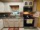 Updated kitchen features white cabinets, stainless steel microwave, and tile backsplash at 2429 S Laurel Ave, Sanford, FL 32771