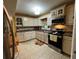 Well-lit kitchen with white cabinets, stainless microwave, and tile flooring at 2429 S Laurel Ave, Sanford, FL 32771