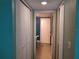 Hallway view leading to bathroom featuring linen closet and standard toilet and shower stall at 25210 Northlake Dr # 210, Sanford, FL 32773