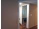View of bathroom with white shower curtain and wood-look flooring through an interior doorway at 25210 Northlake Dr # 210, Sanford, FL 32773