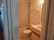 Compact bathroom with standard toilet, vanity and shower stall with light beige walls at 25210 Northlake Dr # 210, Sanford, FL 32773