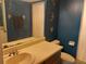 Traditional bathroom with blue walls, vanity and standard toilet with vanity mirror at 25210 Northlake Dr # 210, Sanford, FL 32773
