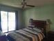 Bedroom with a ceiling fan, closet, and sliding glass doors to an outside patio at 25210 Northlake Dr # 210, Sanford, FL 32773