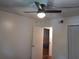 Bedroom with white walls with doorway, ceiling fan and window with curtains at 25210 Northlake Dr # 210, Sanford, FL 32773