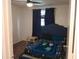 Cozy bedroom featuring a plush bed, side table, and window with dark curtains at 25210 Northlake Dr # 210, Sanford, FL 32773