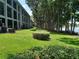 Multi-story condo building with manicured lawn and mature trees overlooking a lake at 25210 Northlake Dr # 210, Sanford, FL 32773