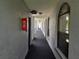 Interior hallway featuring a fire extinguisher, overhead lighting, and carpet at 25210 Northlake Dr # 210, Sanford, FL 32773