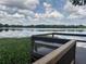 Picturesque lake view showcasing a serene body of water under a sky with fluffy white clouds at 25210 Northlake Dr # 210, Sanford, FL 32773
