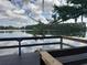 Picturesque lake view from the wooden deck under a partly cloudy sky with beautiful reflections at 25210 Northlake Dr # 210, Sanford, FL 32773