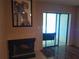 The living room features a fireplace, and a sliding glass door to the outside patio at 25210 Northlake Dr # 210, Sanford, FL 32773