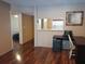 Cozy living room featuring wood floors, a view into the kitchen, and a unique decorative butterfly art piece at 25210 Northlake Dr # 210, Sanford, FL 32773