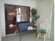 Screened porch with seating featuring open doorway and exterior access at 25210 Northlake Dr # 210, Sanford, FL 32773