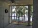 Screened in porch featuring view of lake, trees with moss, dartboard and access to exterior at 25210 Northlake Dr # 210, Sanford, FL 32773