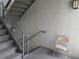 Well-maintained stairwell with safety railings and textured walls at 25210 Northlake Dr # 210, Sanford, FL 32773