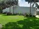 Building wall with colorful landscaping, including tropical plants, set in a vibrant green lawn at 25210 Northlake Dr # 210, Sanford, FL 32773