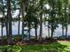 Scenic water view framed by mature trees, captured from a screened lanai at 25210 Northlake Dr # 210, Sanford, FL 32773