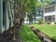 Serene water views, mature trees, with a creek running through the landscaped grounds at 25210 Northlake Dr # 210, Sanford, FL 32773