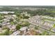 Community aerial view with mature trees, lush greenery, and a distant lake at 2541 Leeward Way, Winter Park, FL 32792