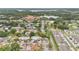 Areal view showcasing the community's layout with mature trees, lush greenery and a distant lake at 2541 Leeward Way, Winter Park, FL 32792