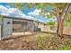 Exterior of the screened-in lanai, looking onto the spacious backyard with natural landscaping at 2541 Leeward Way, Winter Park, FL 32792