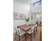 Modern dining area featuring a stylish table set, contemporary artwork, and open kitchen access at 2541 Leeward Way, Winter Park, FL 32792