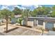Contemporary home exterior with a mix of neutral tones, mature landscaping and inviting front entrance at 2541 Leeward Way, Winter Park, FL 32792