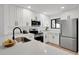 Modern kitchen features white cabinets, stainless steel appliances, and light countertops at 2541 Leeward Way, Winter Park, FL 32792