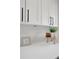 Close up of kitchen countertops with modern décor and white cabinets above at 2541 Leeward Way, Winter Park, FL 32792