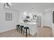 Bright kitchen with stainless steel appliances, sleek white cabinets, and a breakfast bar with seating at 2541 Leeward Way, Winter Park, FL 32792