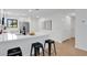 Modern kitchen with stainless steel appliances, white cabinetry, and a quartz countertop breakfast bar at 2541 Leeward Way, Winter Park, FL 32792